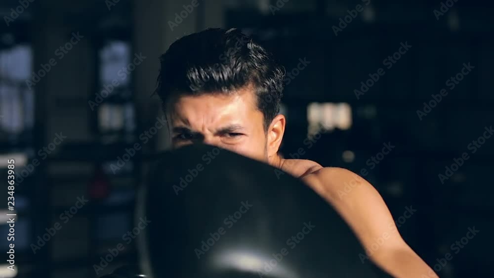 Close up portrait of boxer. Training in box and hitting air right near the camera. Hit the camera at the and. Looks like knockout. Close up portrait of boxer. Training in box and hitting air right near the camera. Hit the camera at the and. Looks like knockout.