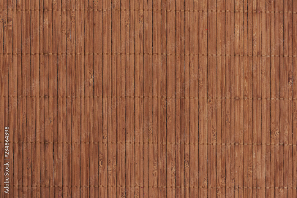 Sushi roll bamboo mat as background.