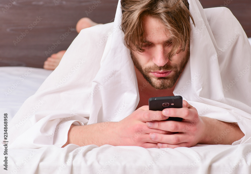 Young man stretching while waking up in the morning. Stretch after wake up in the morning. Relaxed bed man. Young man stretching while waking up in the morning. Stretch after wake up in the morning. Relaxed bed man.