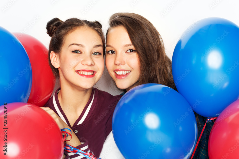 american independence day, holiday and birthday party concept - happy smiling pretty teenage girls with red and blue helium balloons over white background american independence day, holiday and birthday party concept - happy smiling pretty teenage girls with red and blue helium balloons over white background