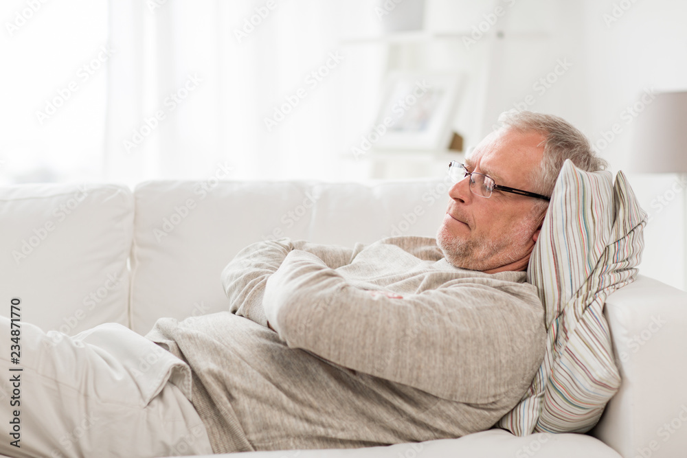 old age, problem and people concept - thoughtful senior man lying on sofa at home old age, problem and people concept - thoughtful senior man lying on sofa at home