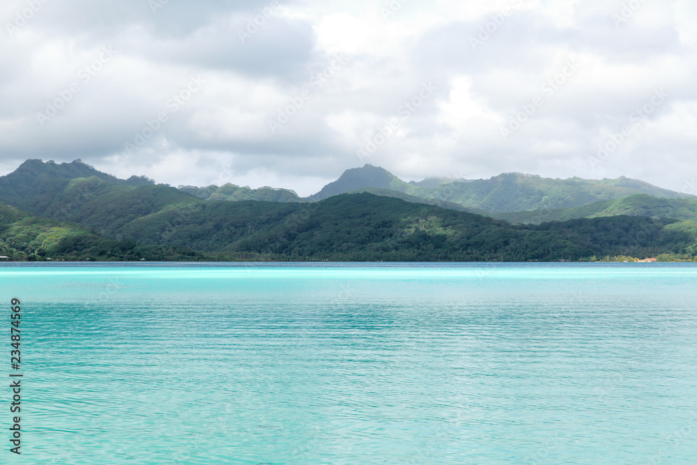 travel, seascape and nature concept - lagoon and mountains in french polynesia