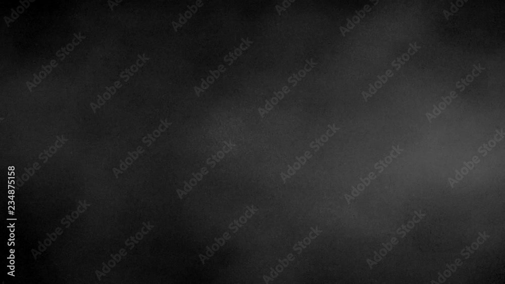 A slow motion smoke effect on a black background A slow motion smoke effect on a black background
