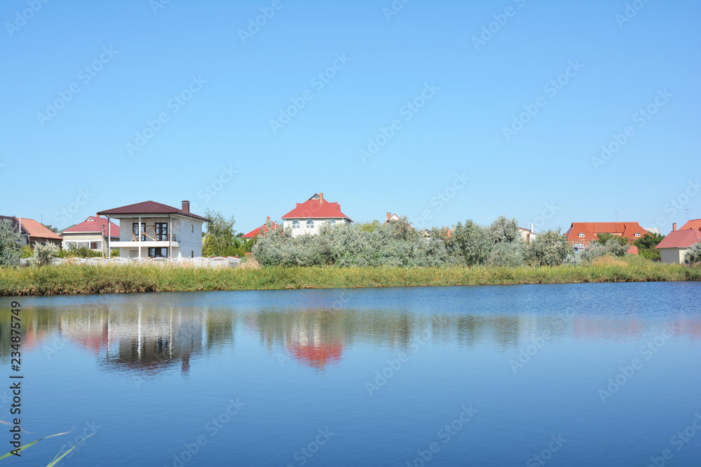 House construction with many houses and cottages on the lake bank with beautiful view.