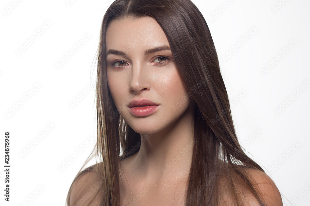 Closeup portrait of a woman with developing straight hair. Sweet tender young girl brunette. Natural lipstick, transparent clean skin. Skin care natural cosmetics in the spa salon or cosmetology. Closeup portrait of a woman with developing straight hair. Sweet tender young girl brunette. Natural lipstick, transparent clean skin. Skin care natural cosmetics in the spa salon or cosmetology.