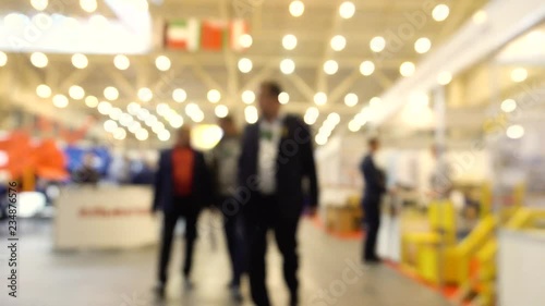 Abstract Defocused Blurred Background flow of many people inside space shopping center or mall, exhibition, exposition, hall real time.