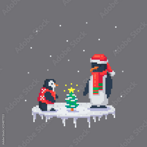 Penguins dressed up a little Christmas tree.