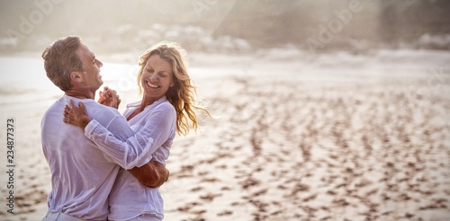 Obraz na płótnie Mature couple having fun together at beach