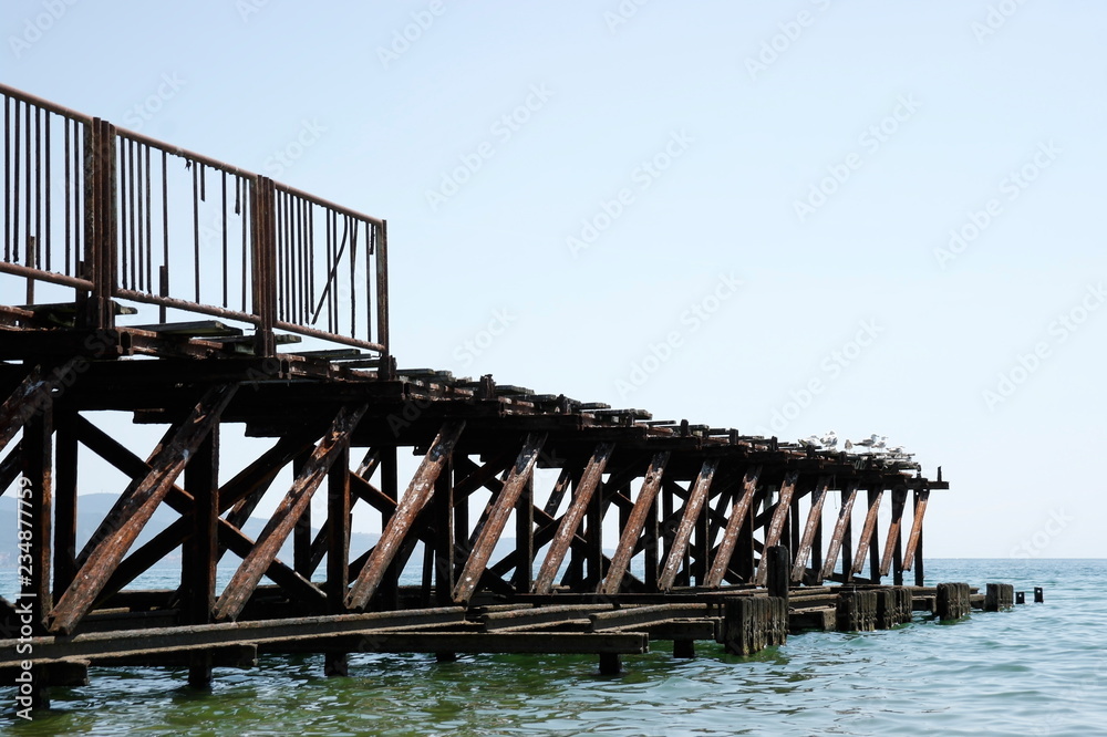 Old wooden pier with metal fences