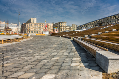 Amphitheater auditorium under the glass translucent roof and stage in Zaryadye Park in early spring day