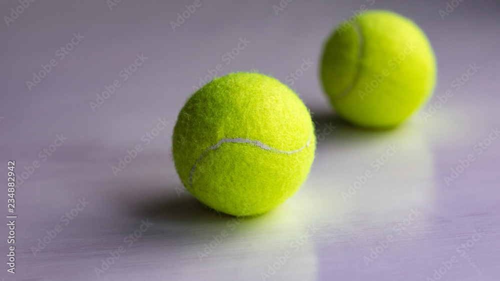 Yellow tennis ball in network package on black background