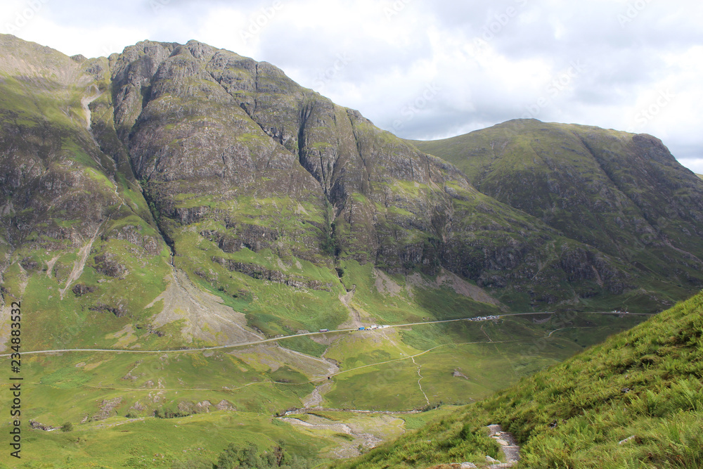Fototapeta premium View of the famous Glencoe pass and A82 road in the Highlands of Scotland, from high above, in the summertime.