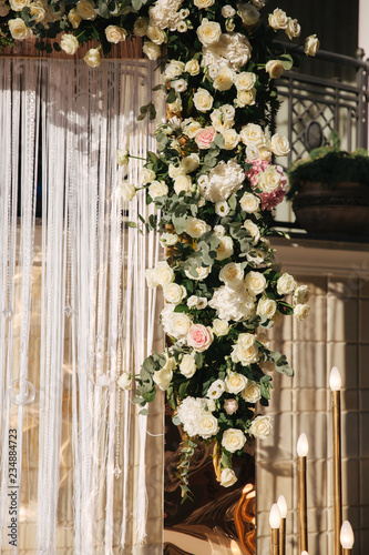 Arch decorated with flowers at the wedding caremony. White and gold color. Rose photo