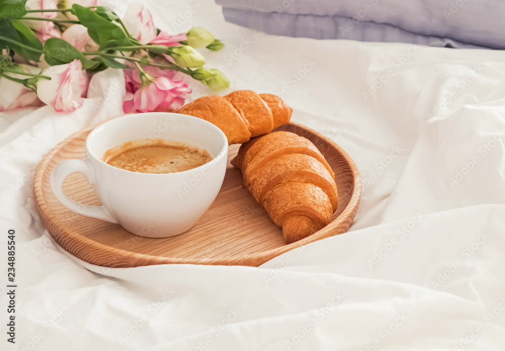 Breakfast in bed with coffee and croissants