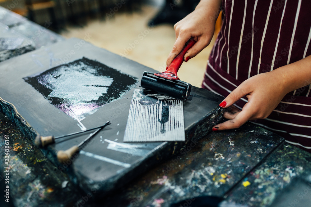 linocut. rolling paint on a piece of linoleum Stock Photo Adobe Stock