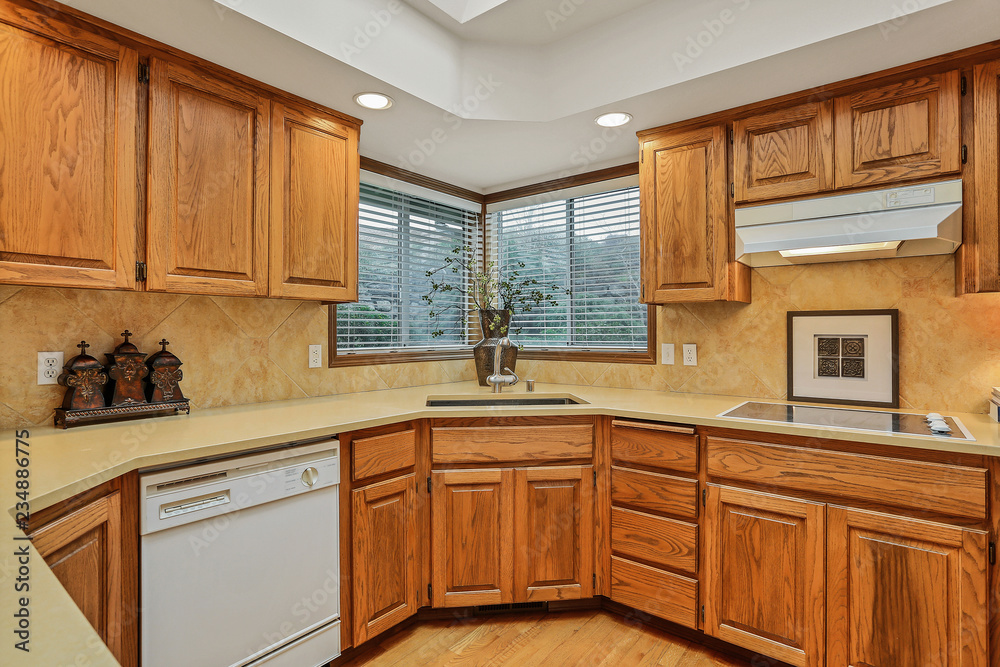 Open large kitchen interior with vaulted ceiling and white appliances. Open large kitchen interior with vaulted ceiling and white appliances.