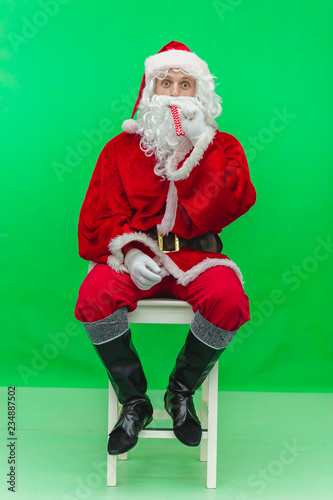 Santa Claus with Party Whistle Horn Ready for Christmas Celebration. Santa Claus celebrating winter holidays. Chroma key