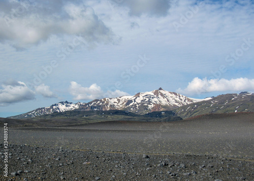 Landscape of Maelifellsandur volcanic black sand desert with Tindafjallajokull glacier and blue sky, summer in Highlands of Iceland photo