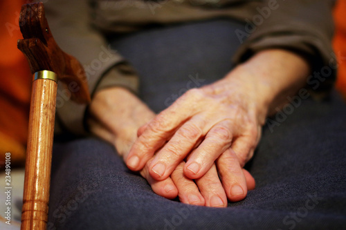 Old woman hands with cane