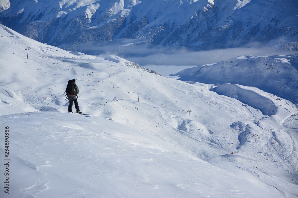 Snowborder at the top of a ski slope
