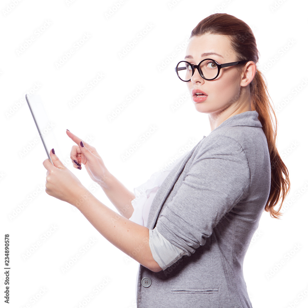 Brunette plus size woman in smart casual outfit (jacker and blouse) on an isolated white background. She holds gadgets in ger hands: tablet and phone. Freelance business concept: work in internet,SMM. Brunette plus size woman in smart casual outfit (jacker and blouse) on an isolated white background. She holds gadgets in ger hands: tablet and phone. Freelance business concept: work in internet,SMM.