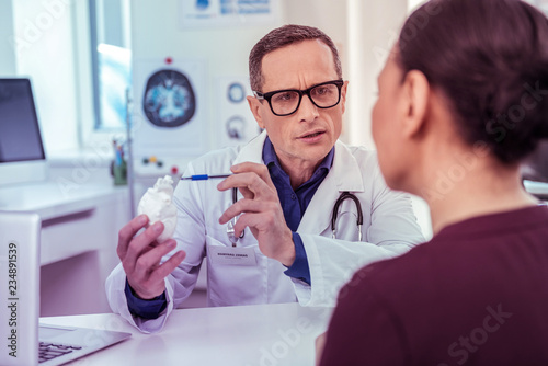 Serious practitioner wrinkling forehead during important talk