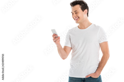 cheerful handsome man using smartphone isolated on white