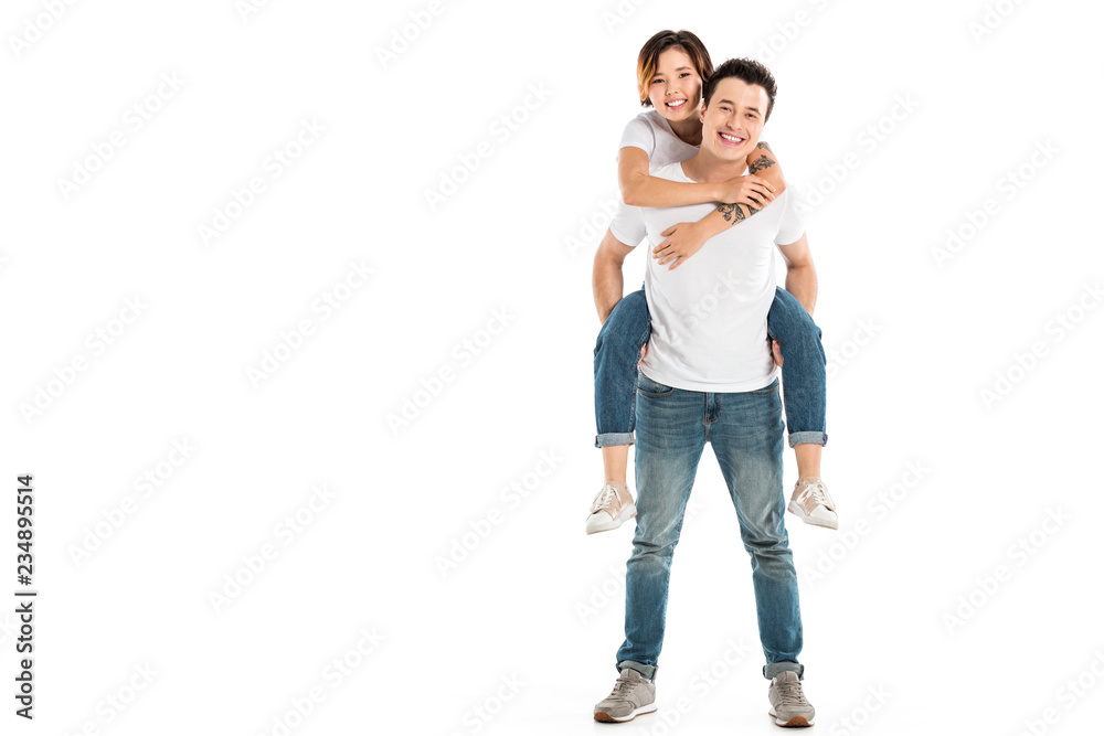 cheerful husband giving piggyback ride to happy wife isolated on white cheerful husband giving piggyback ride to happy wife isolated on white