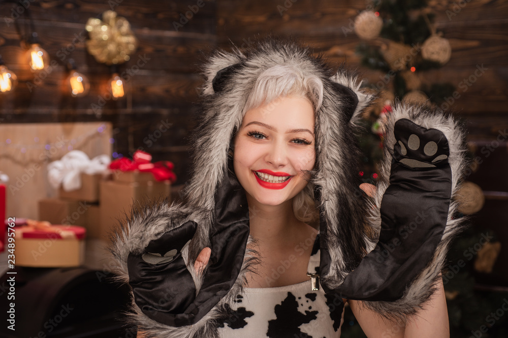 Fototapeta premium Present gift morning before Xmas. Merry Christmas and Happy Holidays. Cheerful girl exchanging gifts. New Year's decorations for holidays and home.