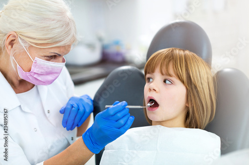 Female dentist and her child patient 