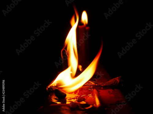 burning candle on black background