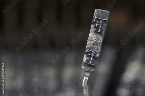close up image of a type hammer on the typewriter