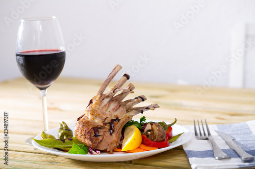 Baked rack of lamb with glass of red wine