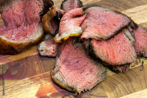 Slices of meat picanha on chopping board