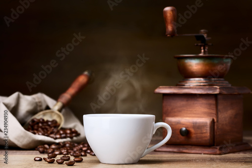 coffee cup with coffee beans and grinder