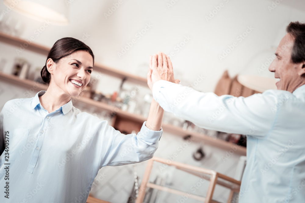 Pleasant joyful woman giving high five to her business partner Pleasant joyful woman giving high five to her business partner