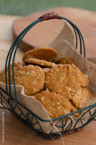 Anzac buscuits in basket on outside table photo