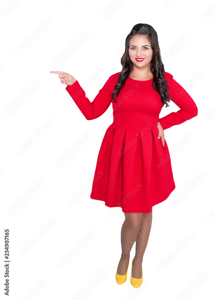 Happy Plus size woman in red dress showing on something on gray Happy Plus size woman in red dress showing on something on gray