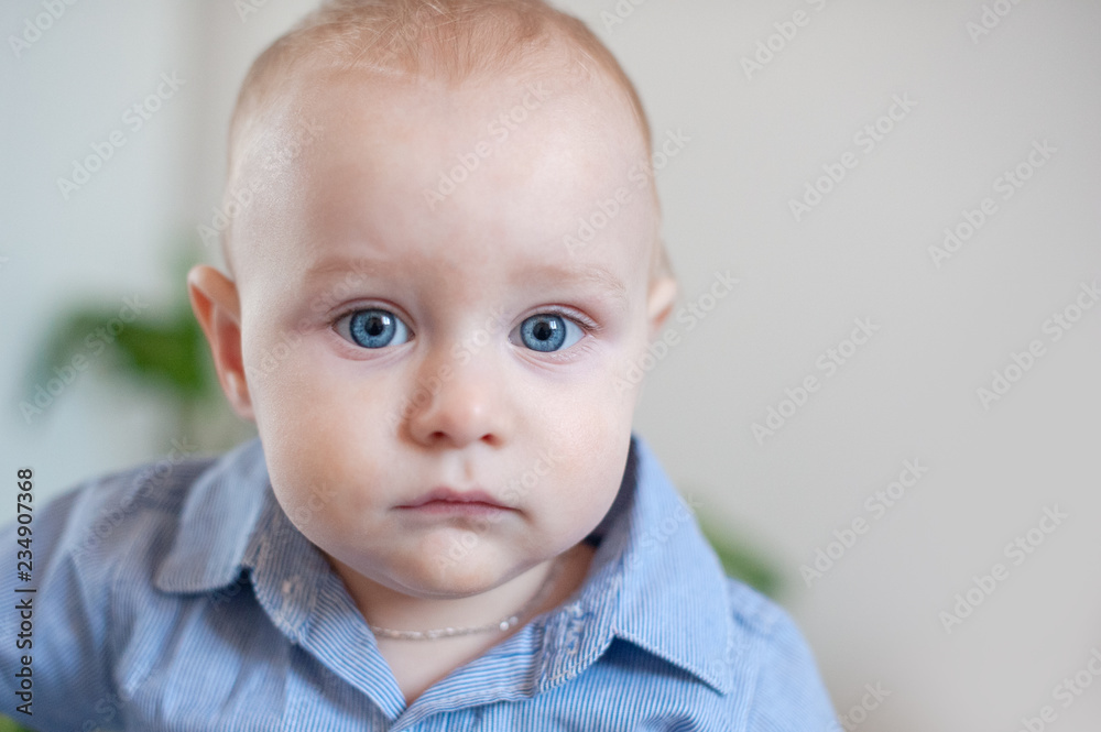 Chubby baby with big blue eyes close-up Chubby baby with big blue eyes close-up