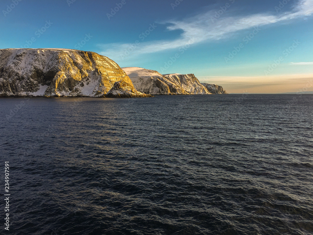 Norway landscape view with ice and snow during winter with a stunning colored sky Norway landscape view with ice and snow during winter with a stunning colored sky