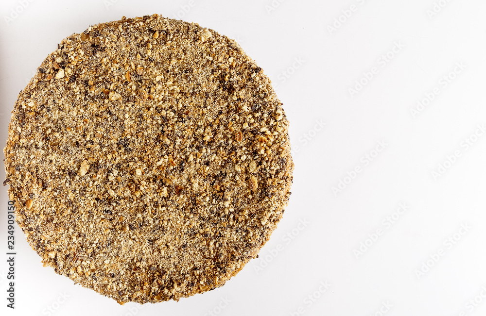 Cake sprinkled with waffle crumbs on a white background. Cake sprinkled with waffle crumbs on a white background.