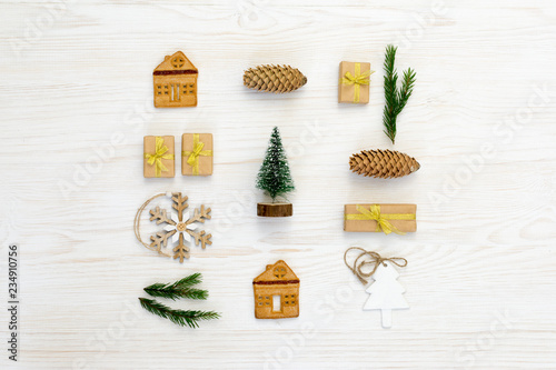 Christmas composition. Christmas gifts, pine cone, wood decorations on white background. Flat lay, top view