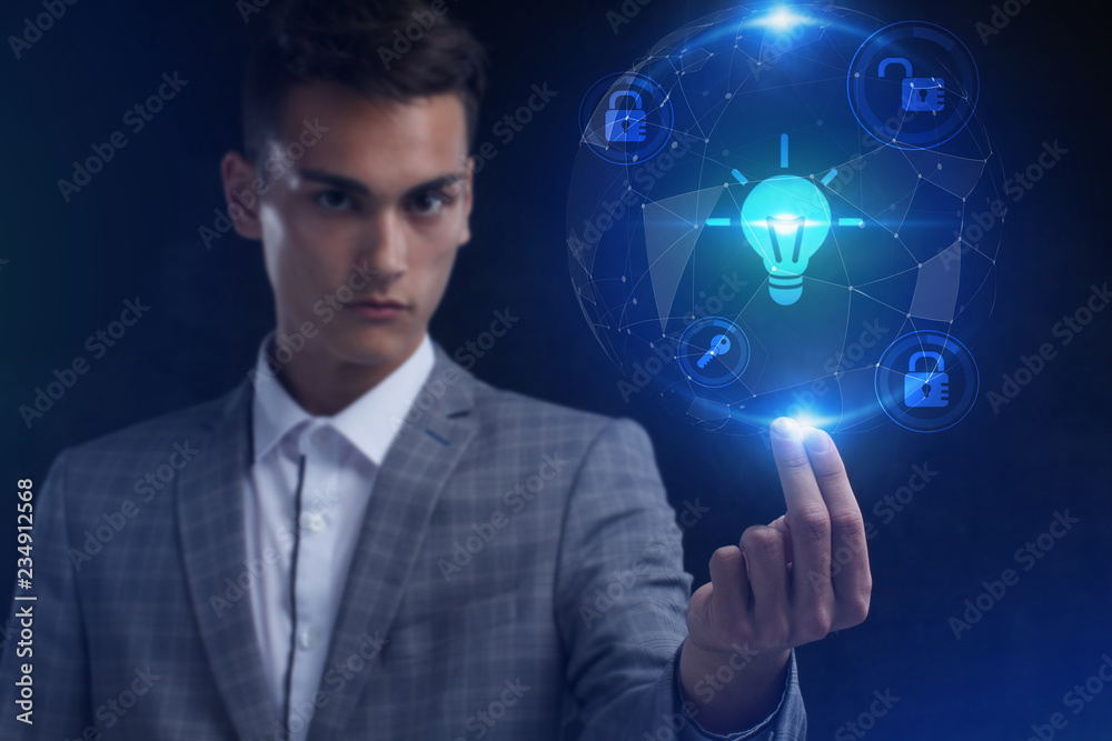The concept of business, technology, the Internet and the network. A young entrepreneur working on a virtual screen of the future and sees the inscription: The concept of business, technology, the Internet and the network. A young entrepreneur working on a virtual screen of the future and sees the inscription: