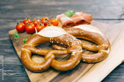 fresh delicious pretzel on wooden background concept