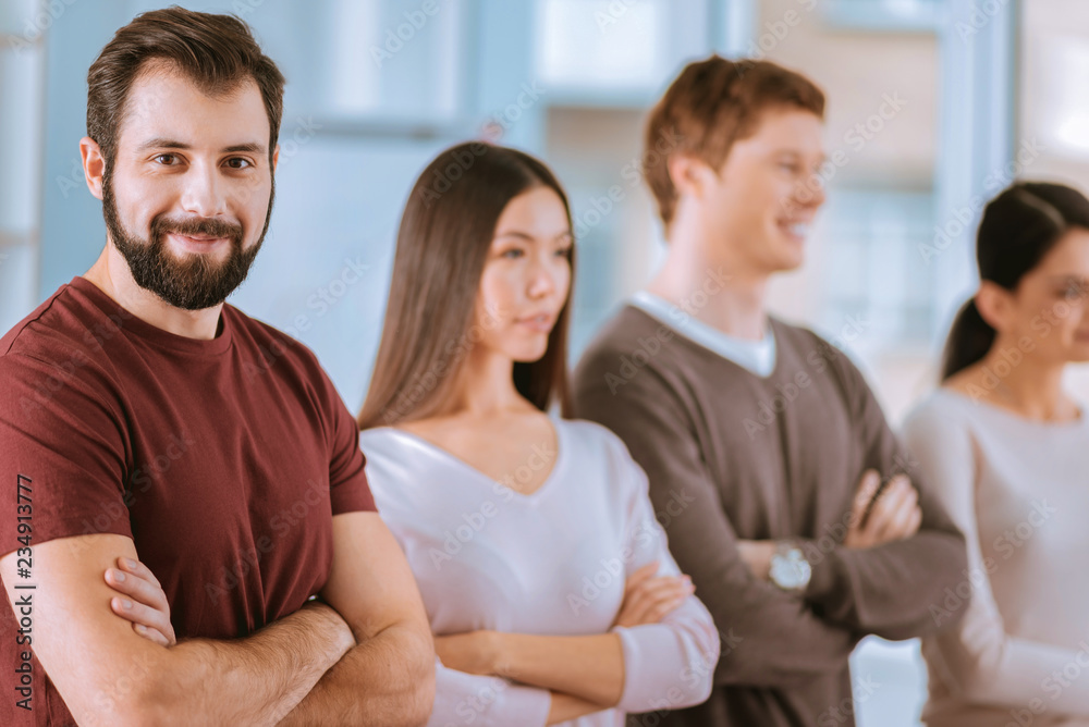 Bearded male colleague determining at result Bearded male colleague determining at result