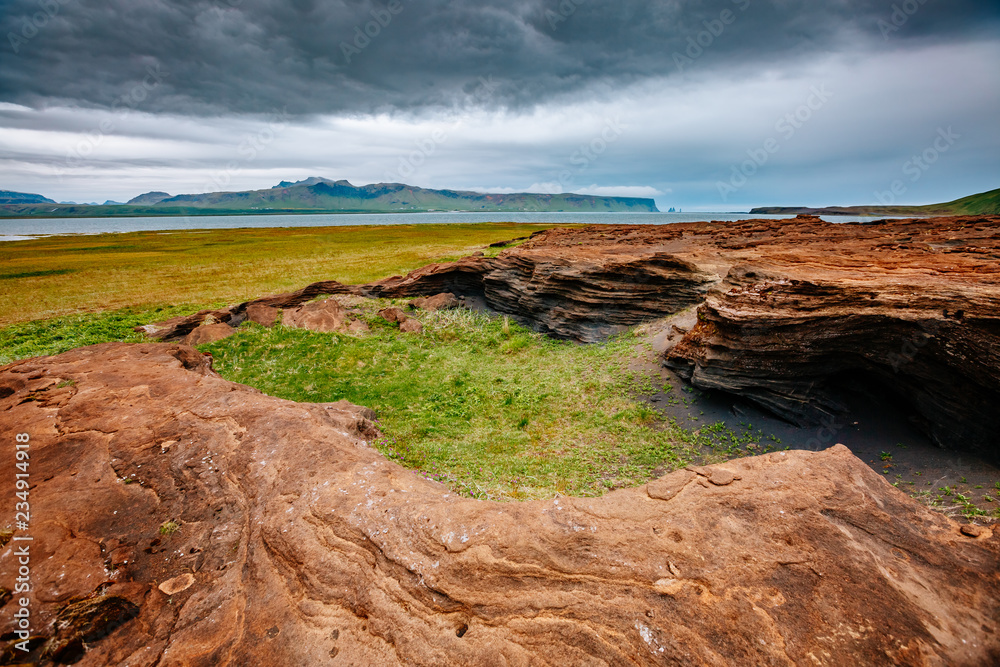 Sandy rocks with by magma formed by winds. Location place Sudurland, Iceland.