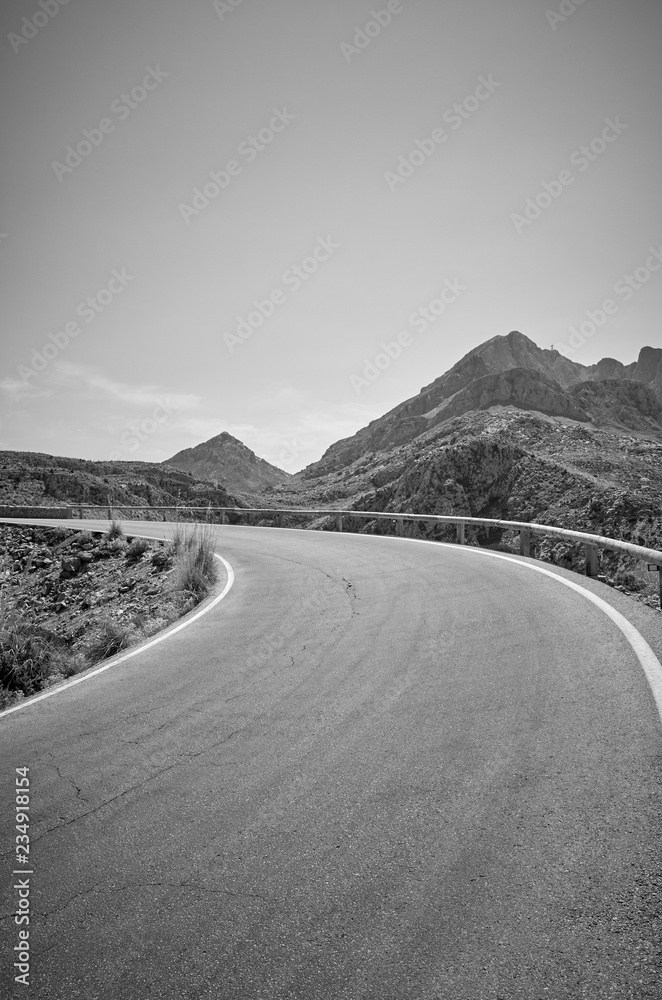 Fototapeta premium Black and white picture of a mountain road.
