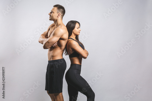 Wallpaper Mural Athletic man and woman isolated over white background. Personal fitness instructor. Personal training. Torontodigital.ca