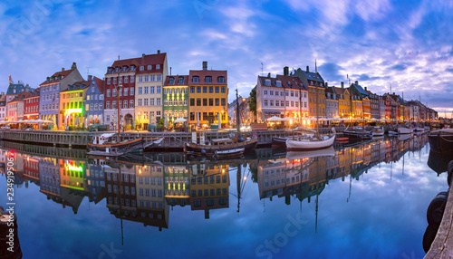 Panoramic view of Nyhavn with colorful facades of old houses and old ships in the Old Town of Copenhagen  capital of Denmark.