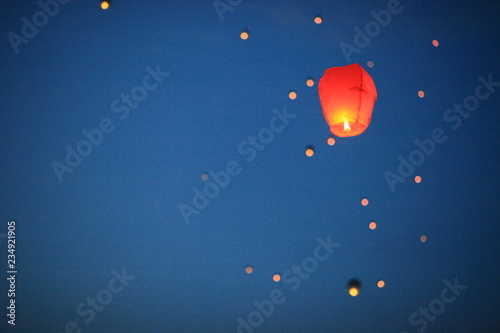 The Chinese lantern flies up highly in the sky.